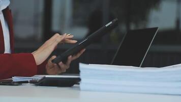 Business woman using calculator for do math finance on wooden desk in office and business working background, tax, accounting, statistics and analytic research concept video