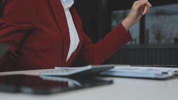 Business woman using calculator for do math finance on wooden desk in office and business working background, tax, accounting, statistics and analytic research concept video