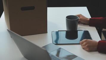 Upset female employee packing belongings in box, frustrated stressed girl getting fired from job ready to leave on last day at work. sad office worker desperate from work video