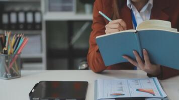 Business woman using calculator for do math finance on wooden desk in office and business working background, tax, accounting, statistics and analytic research concept video