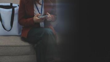 Silhouette of cropped shot of a young man working from home using smart phone and notebook computer, man's hands using smart phone in interior, man at his workplace using technology, flare light video