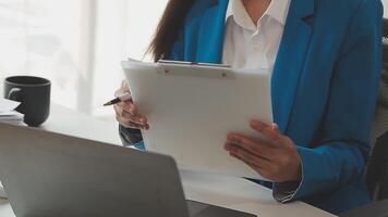 Business woman using calculator for do math finance on wooden desk in office and business working background, tax, accounting, statistics and analytic research concept video