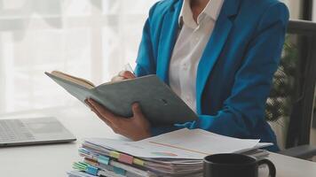 Business woman using calculator for do math finance on wooden desk in office and business working background, tax, accounting, statistics and analytic research concept video