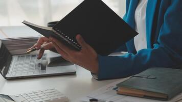 Business woman using calculator for do math finance on wooden desk in office and business working background, tax, accounting, statistics and analytic research concept video
