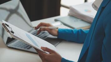 Business woman using calculator for do math finance on wooden desk in office and business working background, tax, accounting, statistics and analytic research concept video
