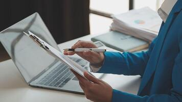Business woman using calculator for do math finance on wooden desk in office and business working background, tax, accounting, statistics and analytic research concept video