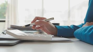 Business woman using calculator for do math finance on wooden desk in office and business working background, tax, accounting, statistics and analytic research concept video