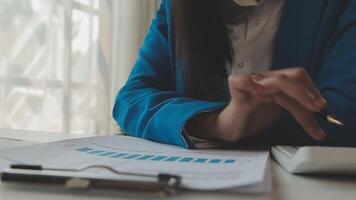 Business woman using calculator for do math finance on wooden desk in office and business working background, tax, accounting, statistics and analytic research concept video