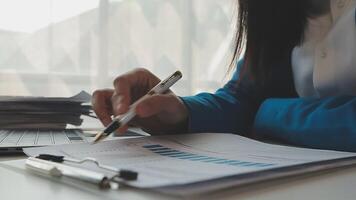 Business woman using calculator for do math finance on wooden desk in office and business working background, tax, accounting, statistics and analytic research concept video