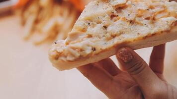 Happy woman eating slice of pizza at sidewalk cafe video