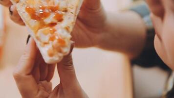 Happy woman eating slice of pizza at sidewalk cafe video