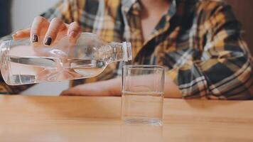 food, leisure and people concept - happy smiling man having dinner at restaurant and pouring water from jug to glass video