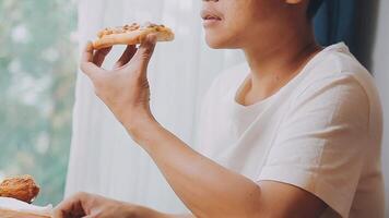 Happy woman eating slice of pizza at sidewalk cafe video