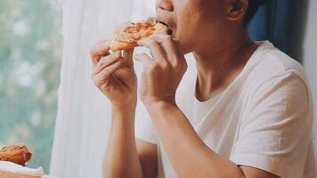 Happy woman eating slice of pizza at sidewalk cafe video