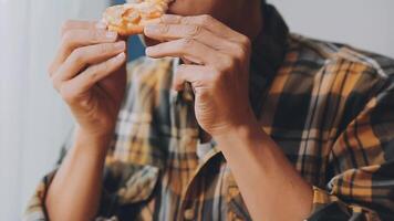 Happy woman eating slice of pizza at sidewalk cafe video