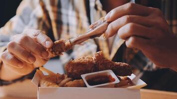 close up focus woman hand hold fried chicken for eat,girl with fast food concept video