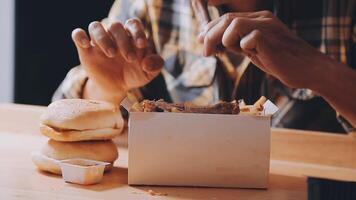 close up focus woman hand hold fried chicken for eat,girl with fast food concept video