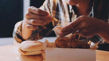 close up focus woman hand hold fried chicken for eat,girl with fast food concept video