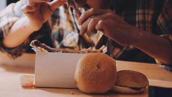 close up focus woman hand hold fried chicken for eat,girl with fast food concept video