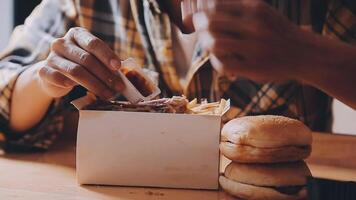 close up focus woman hand hold fried chicken for eat,girl with fast food concept video