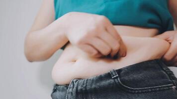 Women body fat belly. Obese woman hand holding excessive belly fat. diet lifestyle concept to reduce belly and shape up healthy stomach muscle. video