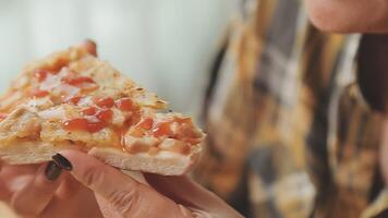 Happy woman eating slice of pizza at sidewalk cafe video