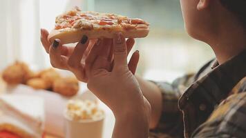 Happy woman eating slice of pizza at sidewalk cafe video