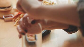 Happy woman eating slice of pizza at sidewalk cafe video