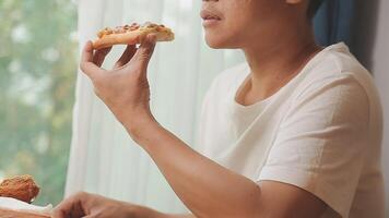 Happy woman eating slice of pizza at sidewalk cafe video