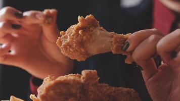 close up focus woman hand hold fried chicken for eat,girl with fast food concept video