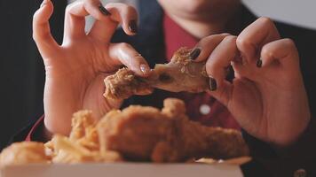 close up focus woman hand hold fried chicken for eat,girl with fast food concept video