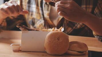 close up focus woman hand hold fried chicken for eat,girl with fast food concept video