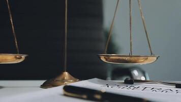 Business and lawyers discussing contract papers with brass scale on desk in office. Law, legal services, advice, justice and law concept picture with film grain effect video