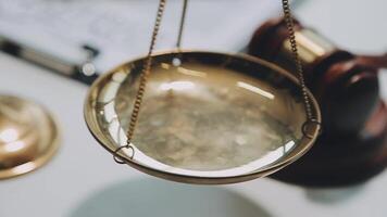 Business and lawyers discussing contract papers with brass scale on desk in office. Law, legal services, advice, justice and law concept picture with film grain effect video