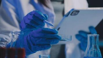 Female Research Scientist Uses Micropipette Filling Test Tubes. Scientist Works in a Team of Scientists Trying to Cure Deadly Disease, They Work in a Big Laboratory Research Center. video