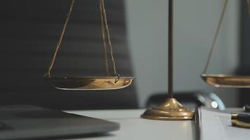 Business and lawyers discussing contract papers with brass scale on desk in office. Law, legal services, advice, justice and law concept picture with film grain effect video