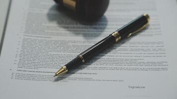 Business and lawyers discussing contract papers with brass scale on desk in office. Law, legal services, advice, justice and law concept picture with film grain effect video