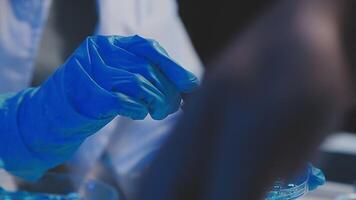 Female Research Scientist Uses Micropipette Filling Test Tubes. Scientist Works in a Team of Scientists Trying to Cure Deadly Disease, They Work in a Big Laboratory Research Center. video