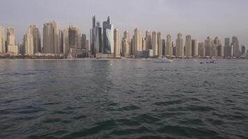 View from a private yacht of a passing jet against the backdrop of Dubai's skyscrapers video