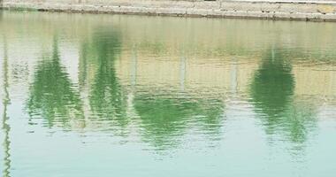 Reflection in the water of the basin of the ancient complex emir's summer residence Sitorai Mohi Xosa. video