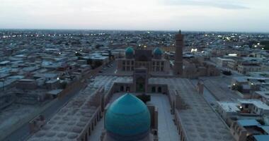 The drone flies at dawn over the old Bukhara and the memorial famous Kalyan Poi Kalon complex and Poi Kalon Minaret, Poi Kalan or Po-i-Kalyan and Mir Arab Madrasah video