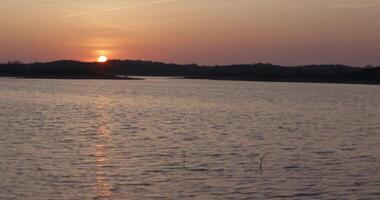 Quiet lake in calm weather during sunset video