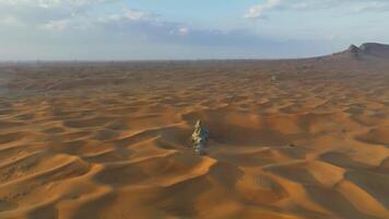 Drone around a lonely rock among the sandy desert video