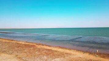 Drone flies over fishermen on the shore of the lake video