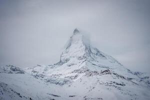 Majestic Matterhorn in Winter, Clouds and Snow, Near Zermatt, Swiss Alps photo