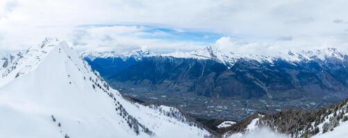 Aerial View of Verbier, Switzerland  Snowy Peaks and Ski Town in the Alps photo