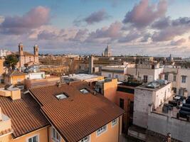 Aerial View of Rome at Sunrise with Historic Buildings and Bell Towers photo