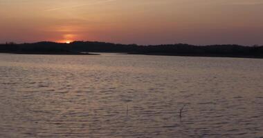 Quiet lake in calm weather during sunset video