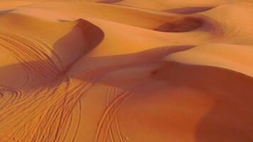 A drone flies over quad bikes driving through the sand dunes of the desert in the United Arab Emirates video