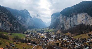 Aerial View of Murren, Switzerland  Alpine Town Amidst Misty Cliffs and Mountains photo